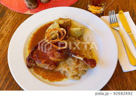 Confit duck leg with sauerkraut and dumplings Confit duck leg with sauerkraut and dumplings 92682692