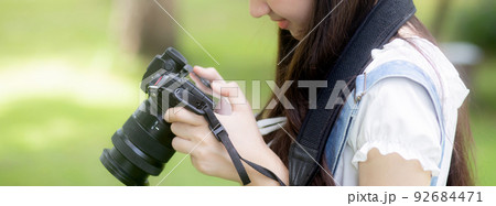 Beautiful happiness young asian woman using camera take a photo for relax in the park. Beautiful happiness young asian woman using camera take a photo for relax in the park. 92684471