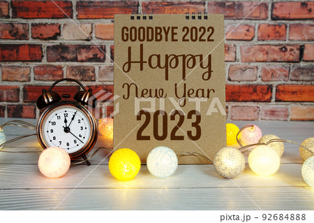 Happy New Year 2023 text message with alarm clock and LED cotton balls decoration 92684888