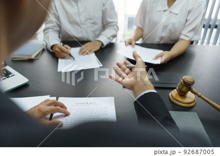 Lawyer and justice concept, Senior lawyer provides advice to couple about their divorce agreement 92687005