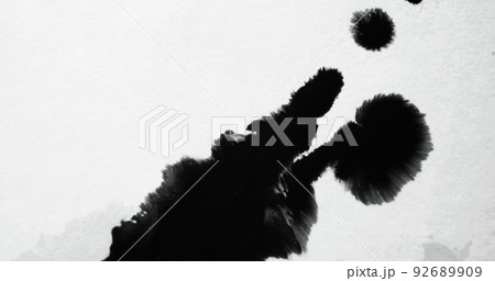 Black ink splash on white paper. Stain texture. Frayed edge overlay. Fluid paint drop blotch on uneven abstract copy space background with defocused motion blur. Black ink splash on white paper. Stain texture. Frayed edge overlay. Fluid paint drop blotch on uneven abstract copy space background with defocused motion blur. 92689909