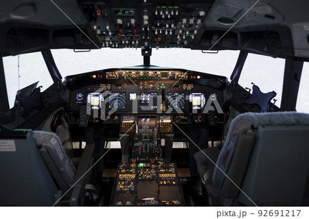 Nobody in airplane cockpit with electronic flying navigation panel, control command with buttons and lever on dashboard. No people in aircraft cabin to throttle engine and takeoff. Nobody in airplane cockpit with electronic flying navigation panel, control command with buttons and lever on dashboard. No people in aircraft cabin to throttle engine and takeoff. 92691217