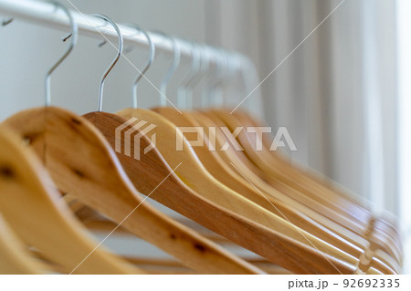 Close-up of wardrobe with wooden clothes hanger, Close-up of wardrobe with wooden clothes hanger, 92692335