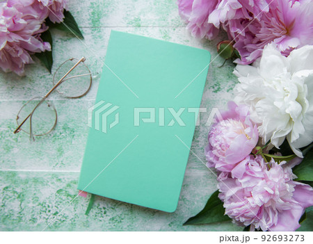 Flat lay paper notebook, eyeglasses, peony flowers 92693273