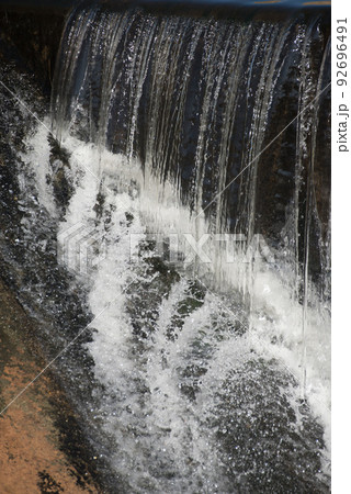 Water flow from upper to lower level.Water splash. 92696491