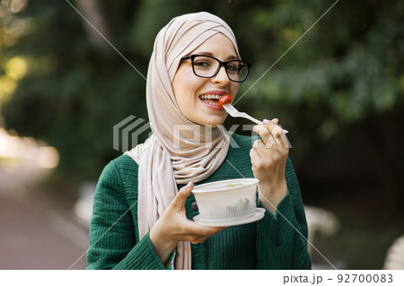 Arab girl eating healthy meal. 92700083