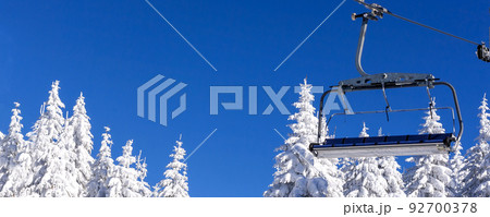 Ski resort, ski lift and snow pine trees 92700378