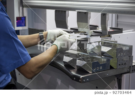 The skill operator working with hydraulic press brake bending machine. 92703464