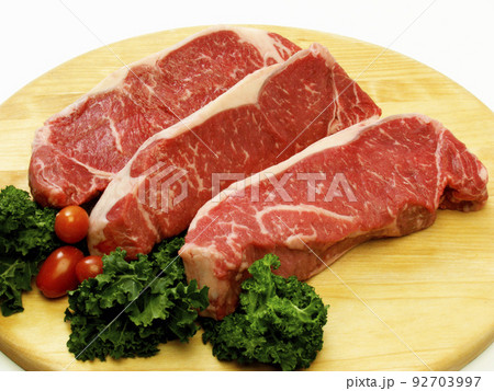 raw steak meat on cutting board in closeup raw steak meat on cutting board in closeup 92703997