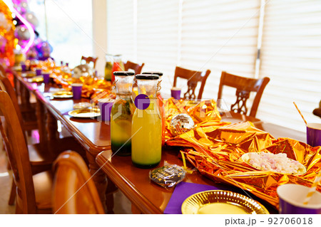 setting of a wooden table on the veranda. golden decor of children's holiday 92706018