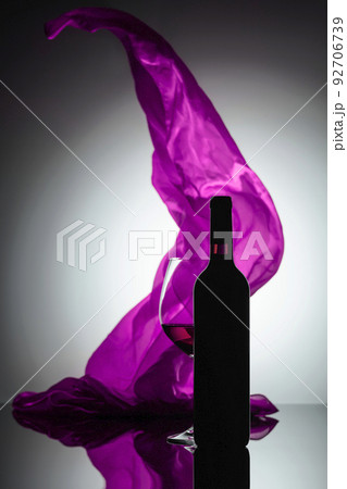 Bottle and glass of red wine. 92706739