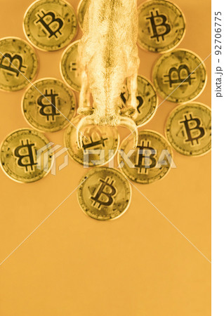 Bull walking over Bitcoins against golden background. Market uptrend concept. Bull walking over Bitcoins against golden background. Market uptrend concept. 92706775