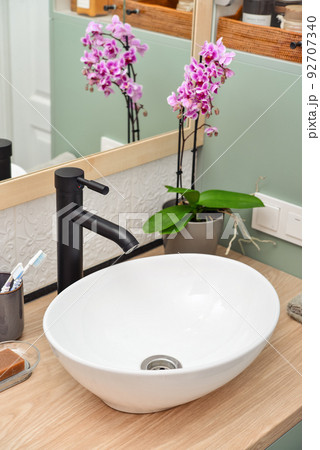 Stylish vessel sink with black basin mixer Stylish vessel sink with black basin mixer 92707340