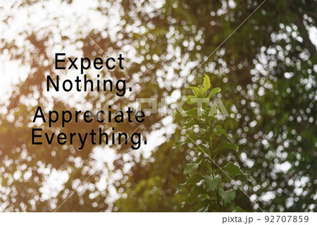 Motivational quote on rainy day background with water drop on green leave. 92707859