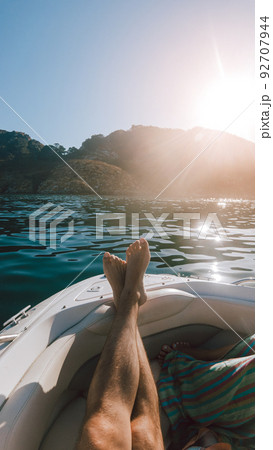 First person view of a man relaxing on a boat First person view of a man relaxing on a boat 92707944