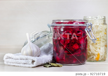 Homemade Sauerkraut with Carrot and Salad Cabbage with Beetroot on a wooden table. Fermented food. 92710719