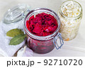Homemade Sauerkraut with Carrot and Salad Cabbage with Beetroot on a wooden table. Fermented food. 92710720