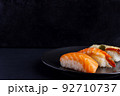 Nigiri sushi set on black background, traditional Japanese food. 92710737
