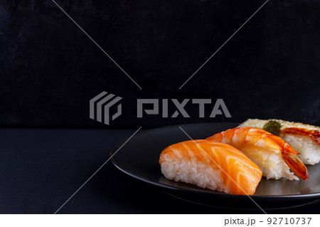 Nigiri sushi set on black background, traditional Japanese food. 92710737