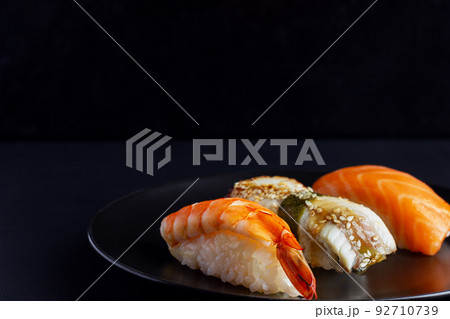 Japanese seafood on dark background. Sushi Set. 92710739