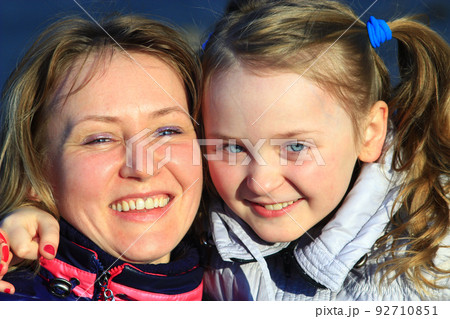 Portrait of happy mother and daughter. Happy family. Two generation Portrait of happy mother and daughter. Happy family. Two generation 92710851