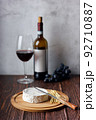 Red wine with cheese plate. Assorted cheeses Camembert and smoke cheese. 92710887