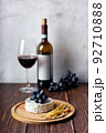 Cheese plate served with red wine and grape. Assorted cheeses Camembert and smoke cheese. 92710888