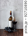 Wine bottles with glass and grape on wooden background. 92710890