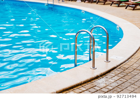 handrails of stairs for descent into the pool. the concept of summer holidays. 92713494