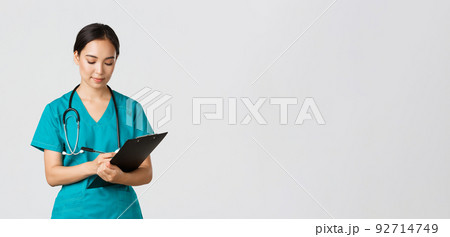 Healthcare workers, preventing virus, quarantine campaign concept. Serious-looking professional female doctor, nurse in scrubs writing down info on clipboard, examine patient, white background 92714749
