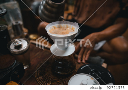 Closeup of hands barista make coffee Closeup of hands barista make coffee 92721573