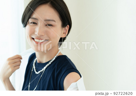 笑顔でシャツを羽織る女性 92722620