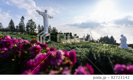 Statues of Jesus and pope forming religious monument surrounded by flowers, Slovakia, Europe 92723142