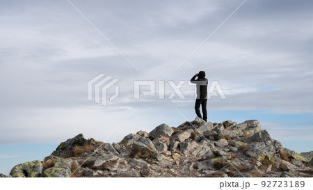 Man using binoculars on the mountain summit, Slovakia, Europe 92723189