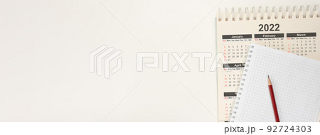 Calendar 2022 and notepad with pencil. Top view Close up calendar Year 2022, planning concept. banner. white paper background Calendar 2022 and notepad with pencil. Top view Close up calendar Year 2022, planning concept. banner. white paper background 92724303