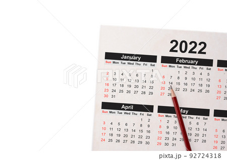 Close-Up Of Pencil On Calendar 2022. Closed up of pencil on calendar on white using as writing agenda or important memo and appointment and planning on calendar. copy space 92724318