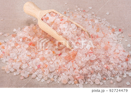 Pink himalayan salt. Close-up Himalayan Pink Rock Salt In wooden Spoon on black background. Fine grains of Pink Himalayan salt Pink himalayan salt. Close-up Himalayan Pink Rock Salt In wooden Spoon on black background. Fine grains of Pink Himalayan salt 92724479