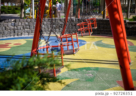 Swing on playground, Set of chain swings on modern kids playground Swing on playground, Set of chain swings on modern kids playground 92726351
