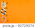 BOO lettering in Halloween style. Orange background and black spiders. Place for text. Copy space. Halloween concept. Flay lay. Top view. 92729374