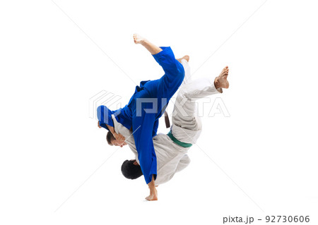 Portrait of two sportive men, professional martial arts fighters training isolated over white background Portrait of two sportive men, professional martial arts fighters training isolated over white background 92730606