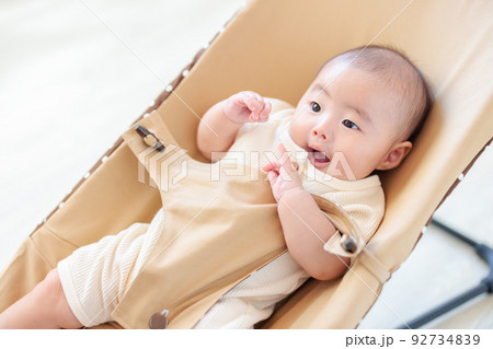 バウンサーに乗る元気な赤ちゃん　クーイング 92734839