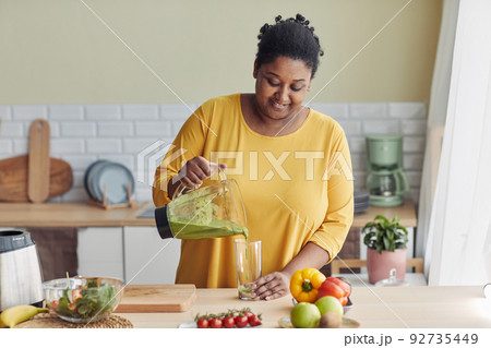Overweight Woman Enjoying Healthy Smoothie Overweight Woman Enjoying Healthy Smoothie 92735449
