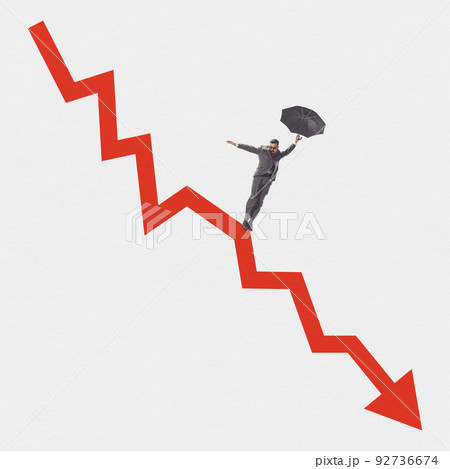Young man near huge red arrow as indicator of fall in the exchange rate, decrease in standard of living of population. Global crisis problems Young man near huge red arrow as indicator of fall in the exchange rate, decrease in standard of living of population. Global crisis problems 92736674