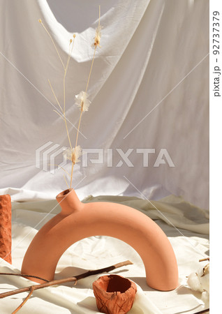 Earthenware vases and objects, pastel terracotta colors, with still life like vegetation Earthenware vases and objects, pastel terracotta colors, with still life like vegetation 92737379