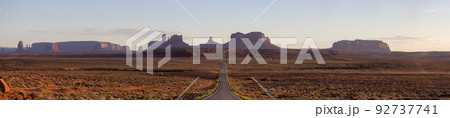 Scenic Road in the Dry Desert with Red Rocky Mountains in Background. Scenic Road in the Dry Desert with Red Rocky Mountains in Background. 92737741