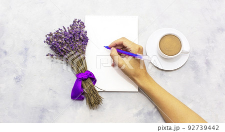 Dried lavender flowers bunch close-up on grey background with white cup of coffee Dried lavender flowers bunch close-up on grey background with white cup of coffee 92739442