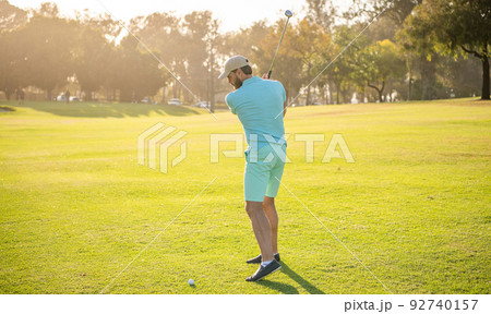 back view of male golf player on professional course with green grass, recreation 92740157