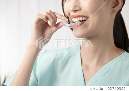 片手でマウスピースを持つ女性 92740392
