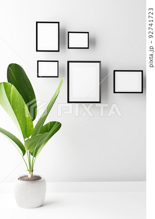 Portrait frame mockup with palm on white wall. 3d render Portrait frame mockup with palm on white wall. 3d render 92741723