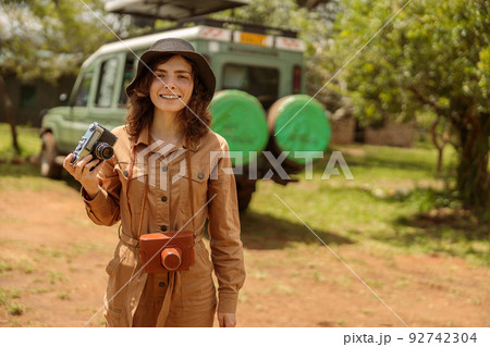 Happy woman on safari using photo camera 92742304